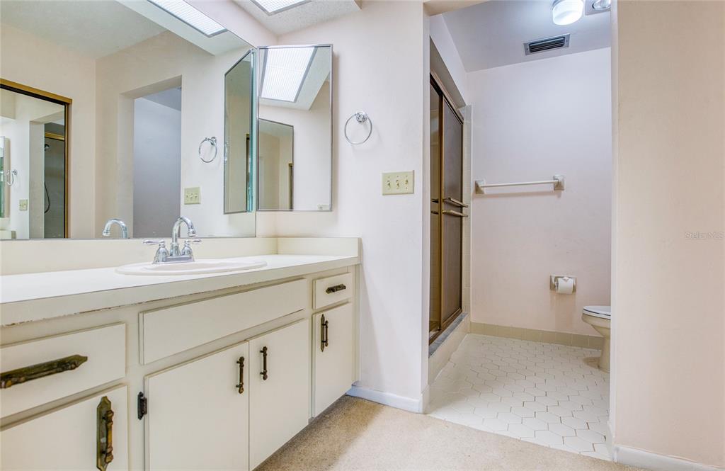 700 Starkey Road, Unit 1145 Largo, FL 33771 - Photo 27 of 63 a spacious bathroom with a double vanity sink and mirror