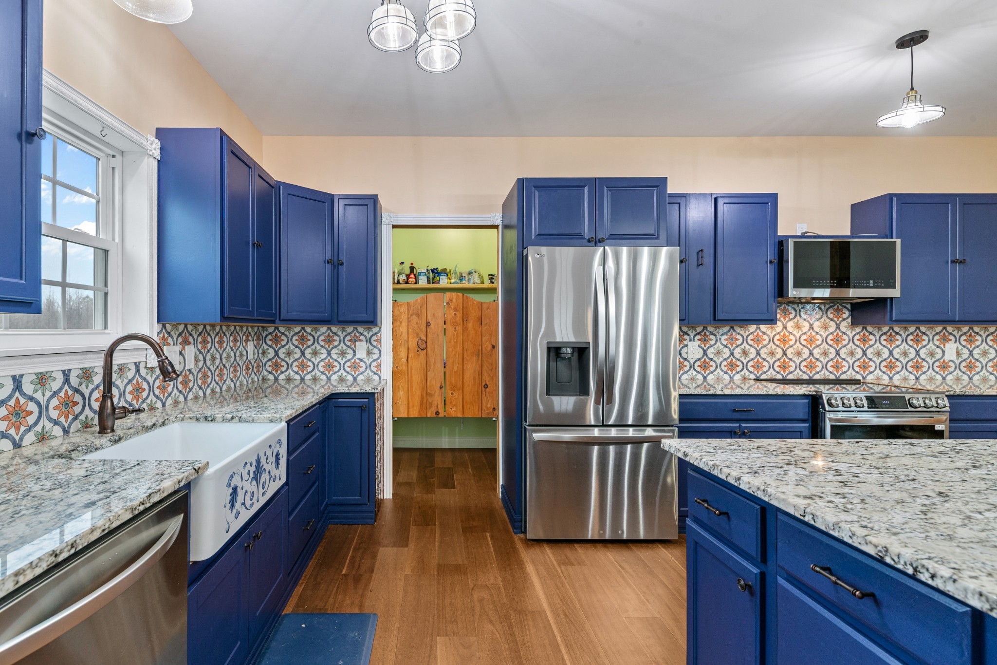 1221 Johnson Branch Road Pulaski, TN 38478 - Photo 29 of 99 a kitchen with stainless steel appliances granite countertop a refrigerator a stove and a wooden floors