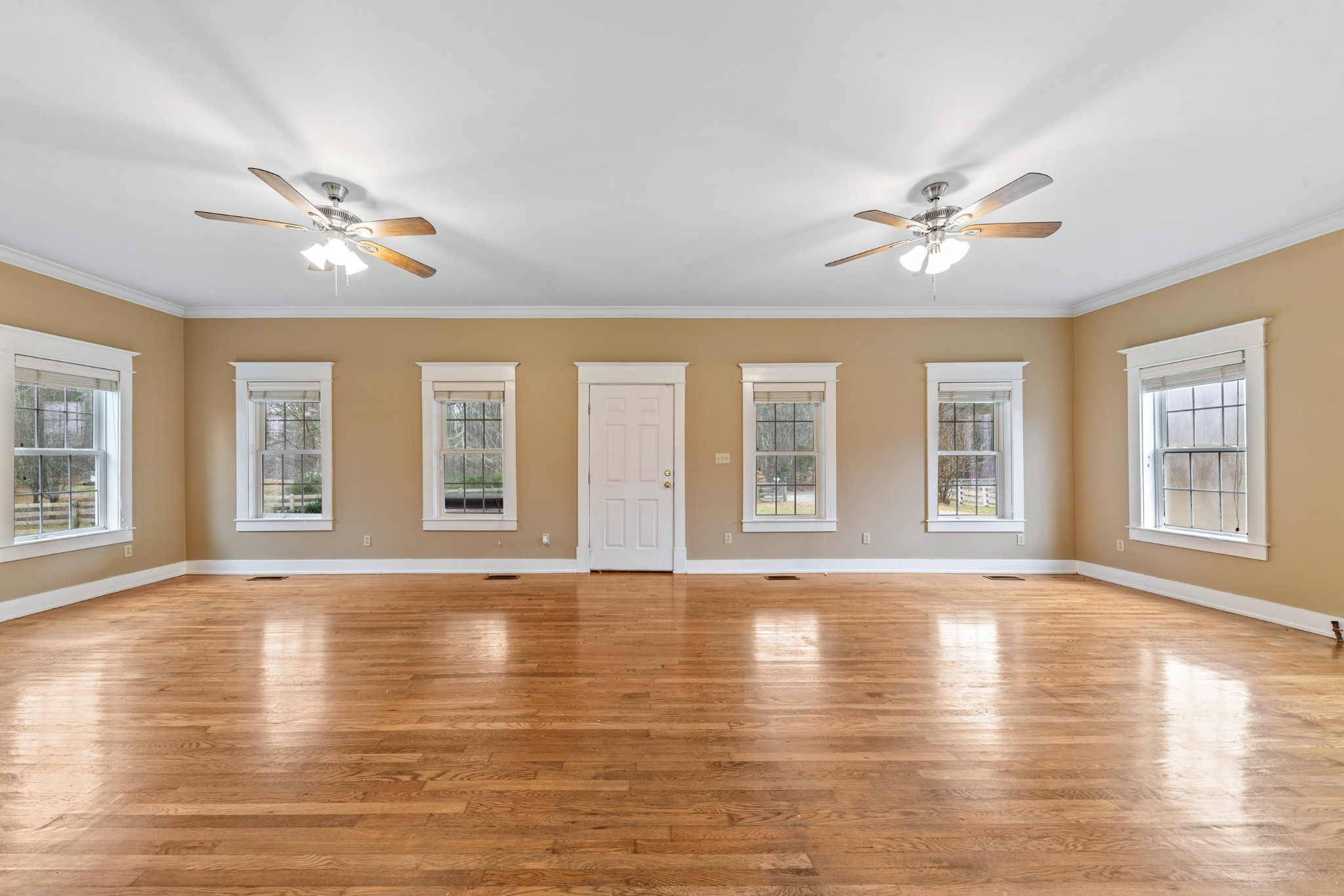 1221 Johnson Branch Road Pulaski, TN 38478 - Photo 60 of 99 a view of an empty room with wooden floor and chandelier fan