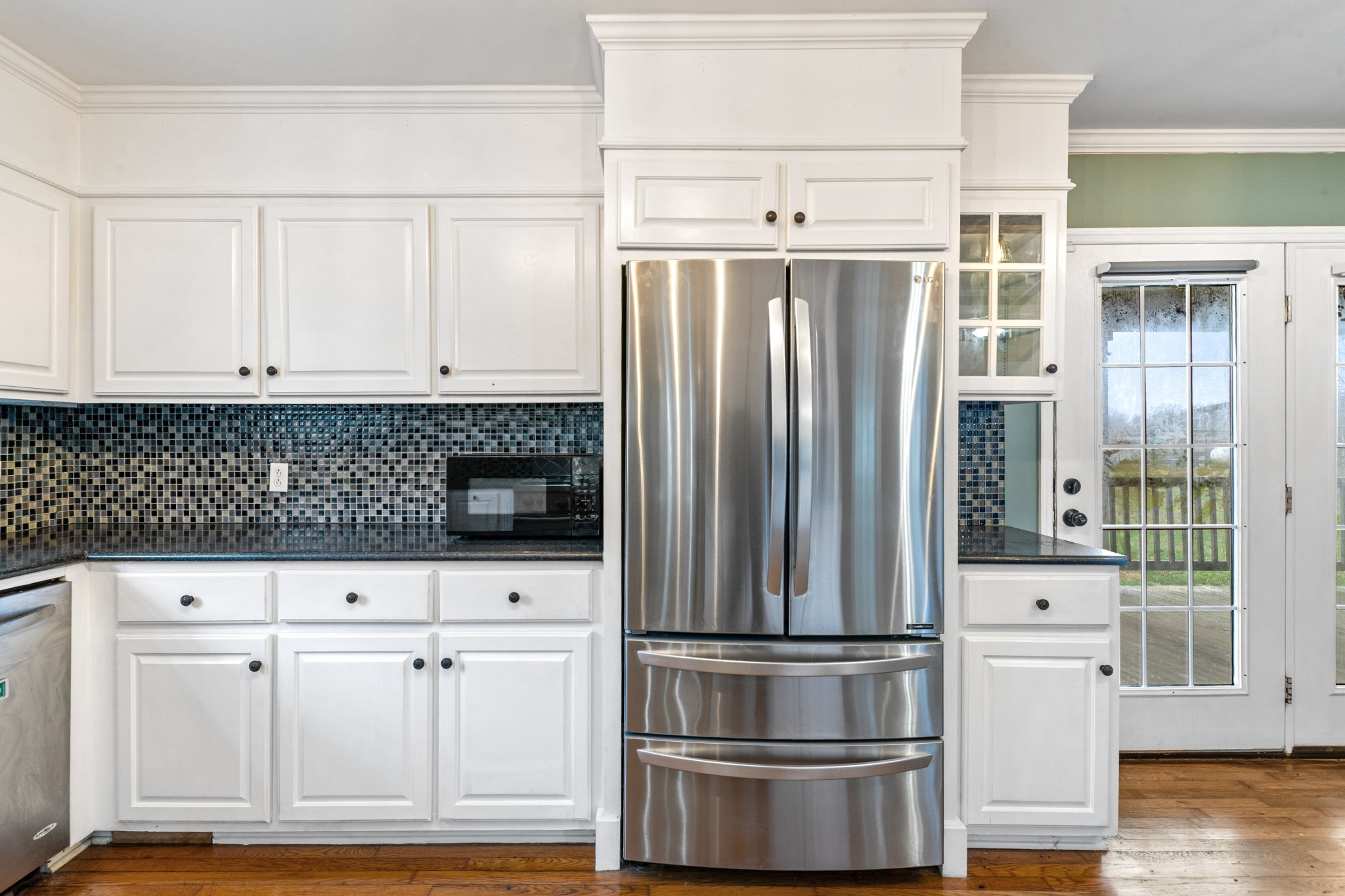 1221 Johnson Branch Road Pulaski, TN 38478 - Photo 67 of 99 a kitchen with white cabinets and stainless steel appliances