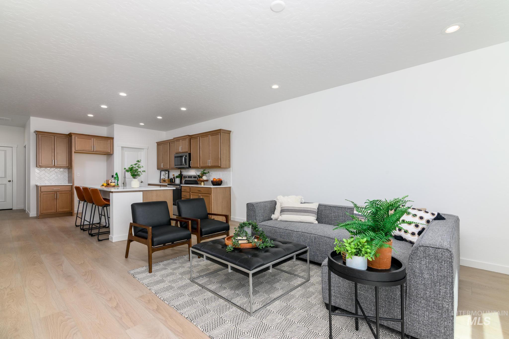 14742 Wing Spread Drive Caldwell, ID 83607 - Photo 3 of 10 Living area featuring recessed lighting and light wood-style flooring