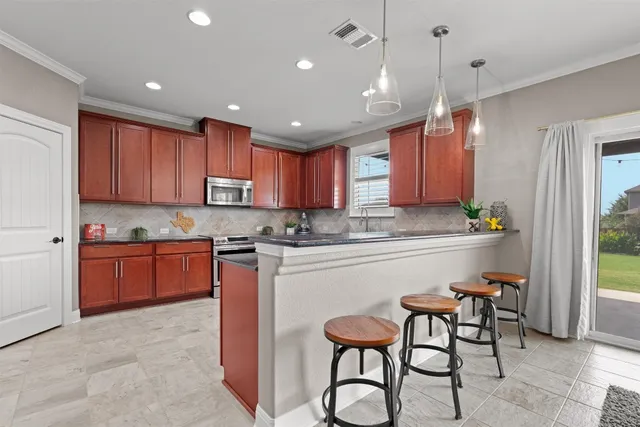 a kitchen with a sink cabinets and window