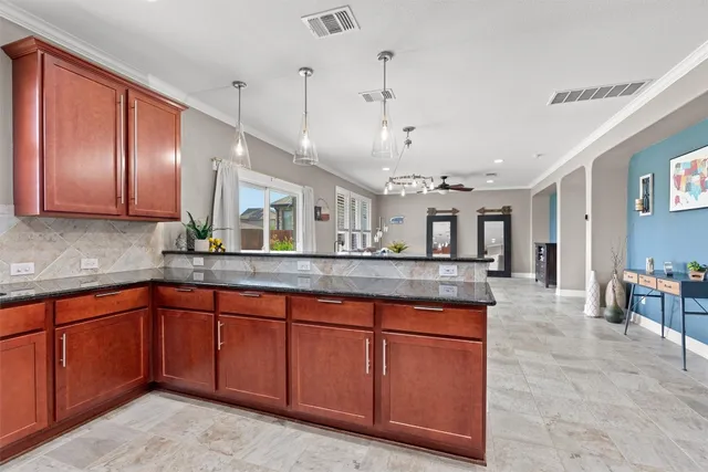 a large kitchen with kitchen island a sink table and chairs