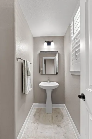 a bathroom with a sink toilet and mirror