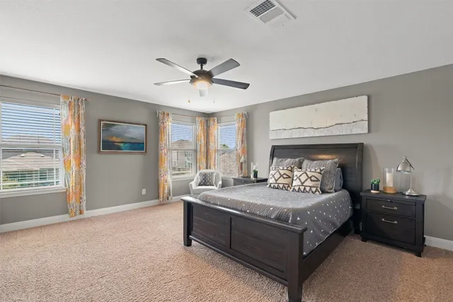 a bedroom with a large bed and a window