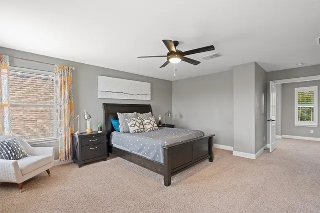 a living room with a bed furniture and a window