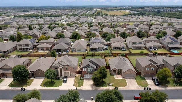 an aerial view of residential houses with outdoor space
