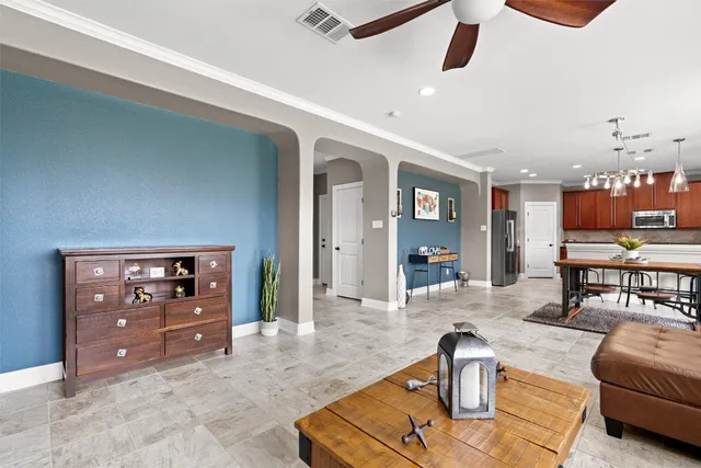 a living room with furniture and view of kitchen