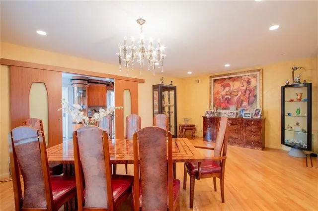 a view of a dining room with furniture and chandelier