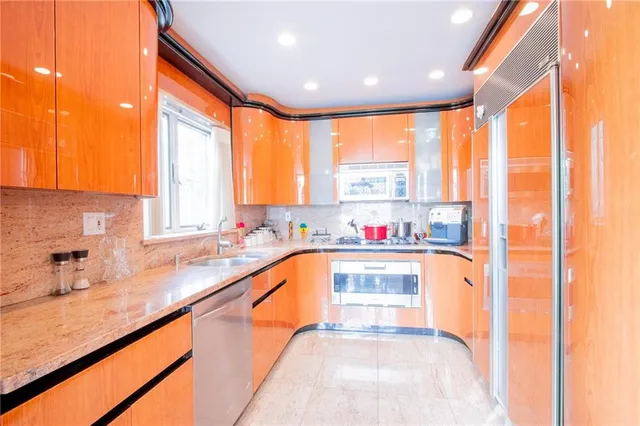 a kitchen with stainless steel appliances a sink and a window