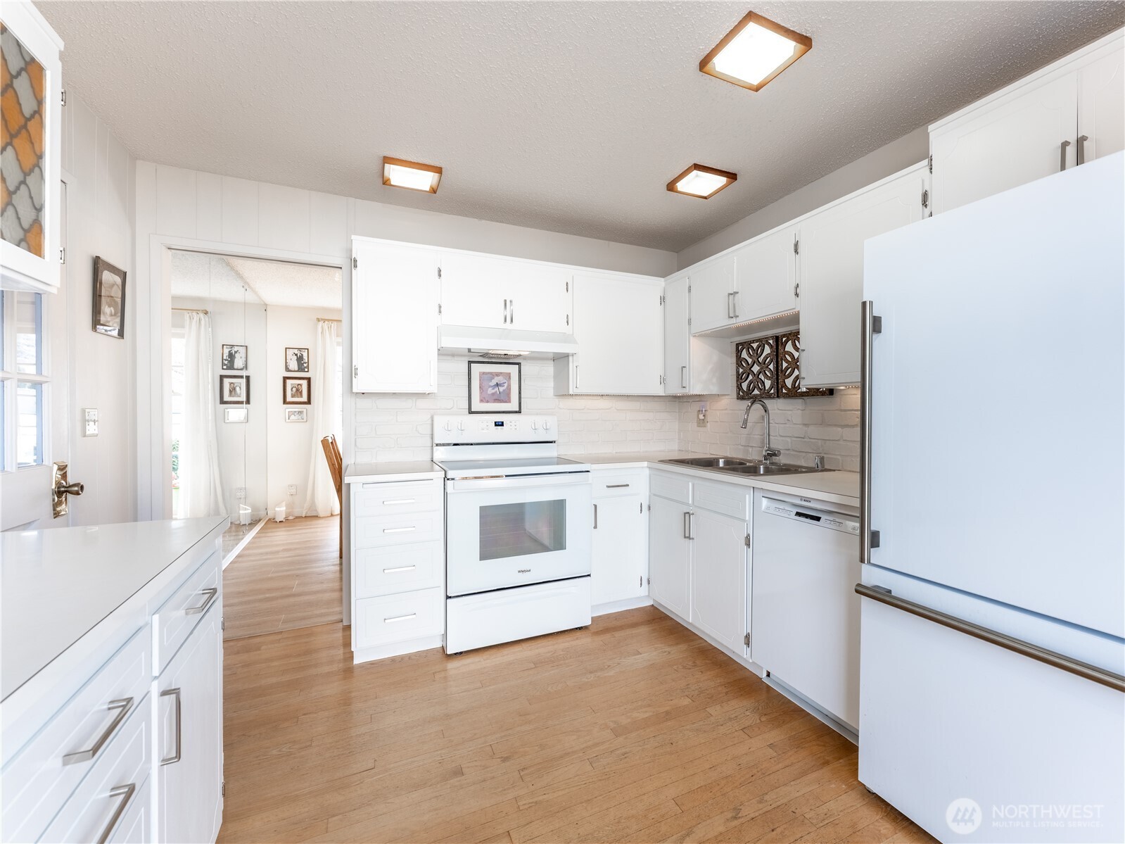 934 Stevens Street Wenatchee, WA 98801 - Photo 12 of 39 a kitchen with white cabinets and white appliances