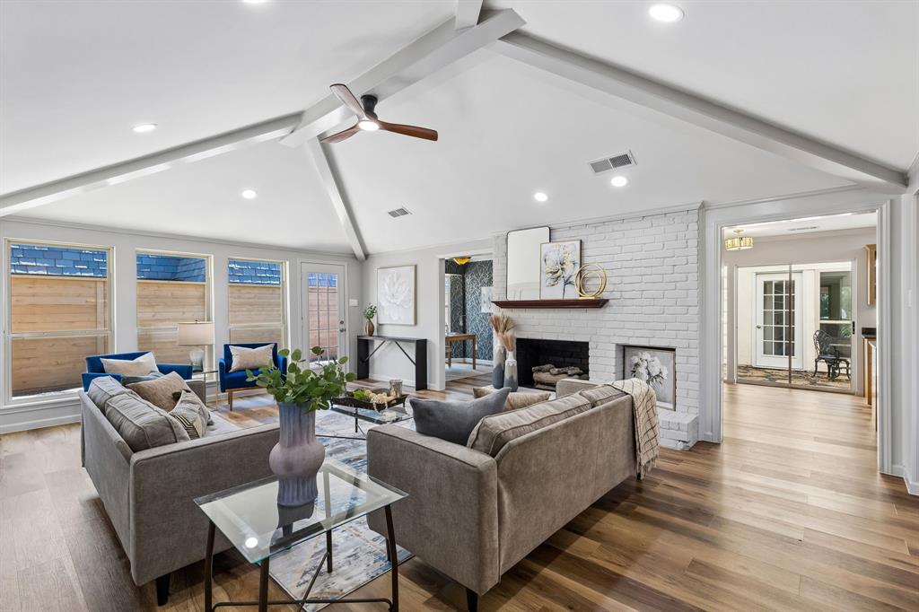 Huge beautiful living room with vaulted ceilings, fireplace and view to side yard with brand new fence.