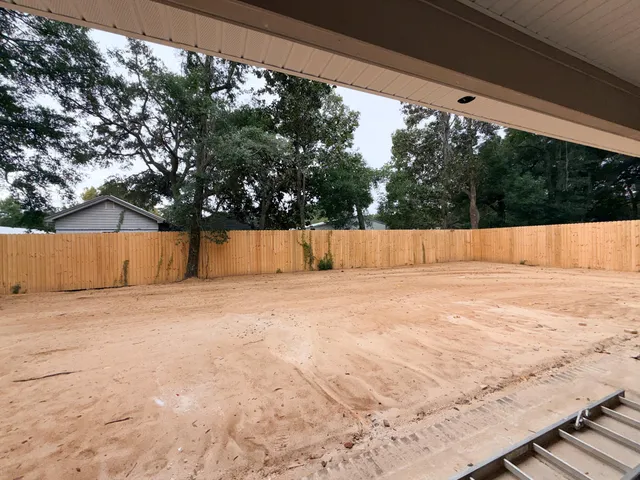a view of backyard and tree