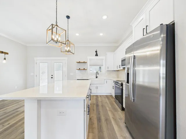 a kitchen with stainless steel appliances a refrigerator sink and cabinets