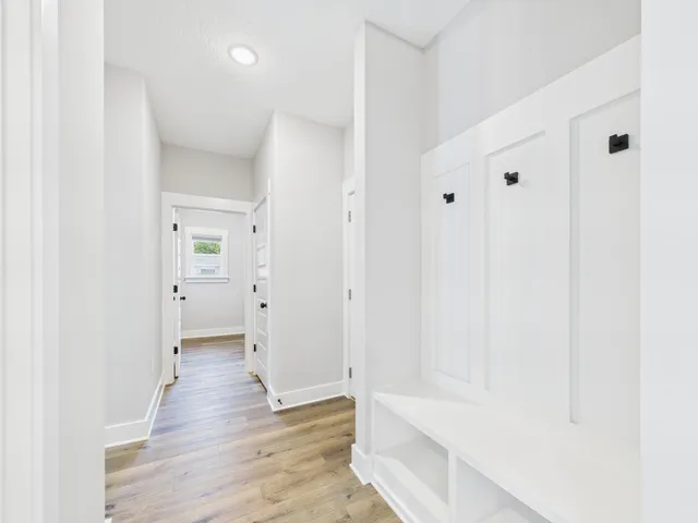 a view of a hallway with wooden floor