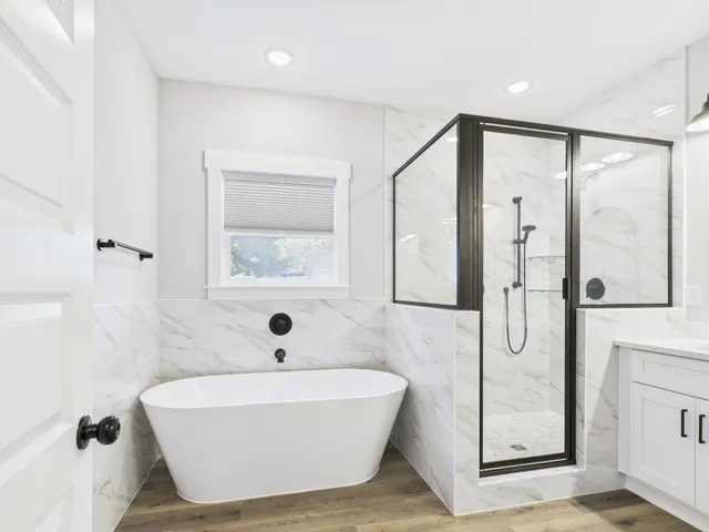 a bathroom with a bathtub and shower