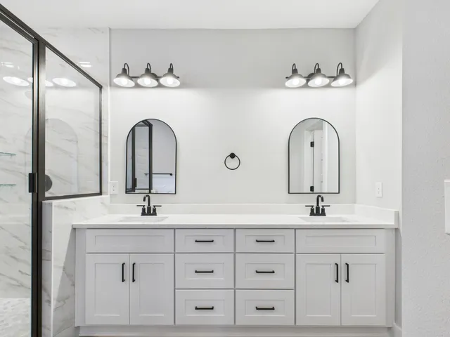 a bathroom with a tub sink and mirror