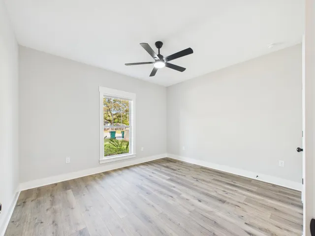 a view of a big room with wooden floor and windows in a room