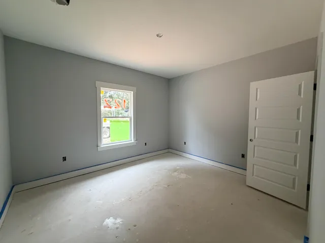 an empty room with windows and closet