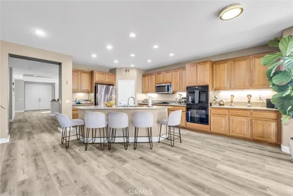 a kitchen with a table chairs refrigerator and cabinets