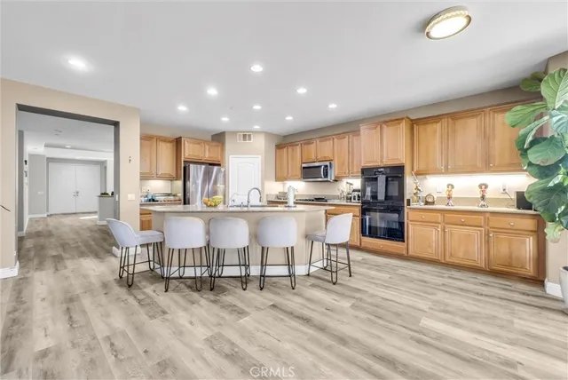 a kitchen with a table chairs refrigerator and cabinets