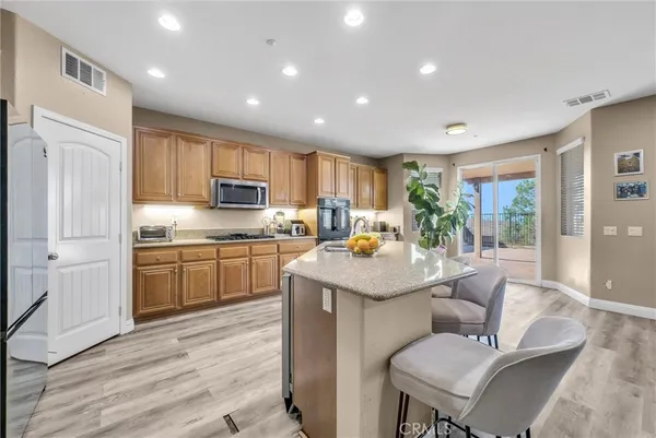 a kitchen with a sink stainless steel appliances and white cabinets