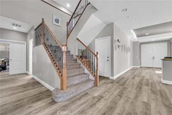 a view of entryway and hall with wooden floor