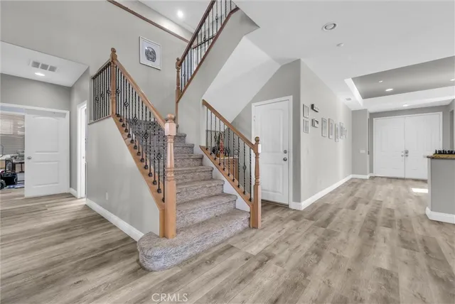 a view of entryway and hall with wooden floor
