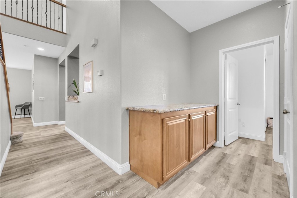 18388 Hidden Ranch Road Riverside, CA 92508 - Photo 17 of 49 a view of a hallway with wooden floor and entryway