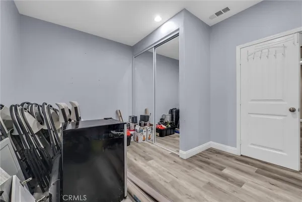 a view of a room with wooden floor and furniture