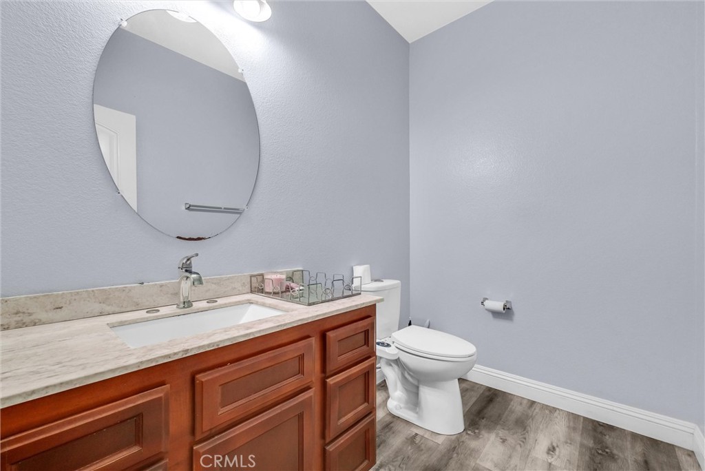 18388 Hidden Ranch Road Riverside, CA 92508 - Photo 20 of 49 a bathroom with a granite countertop sink a toilet and a mirror