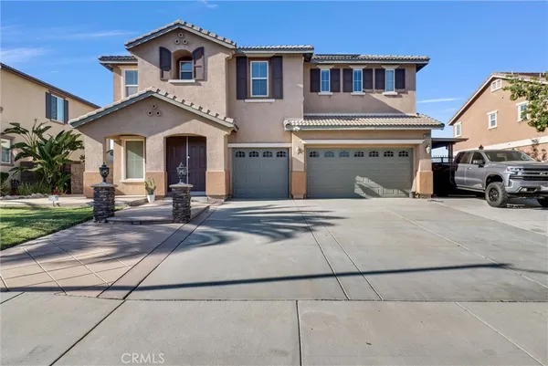a view of a white house with a large windows and a yard