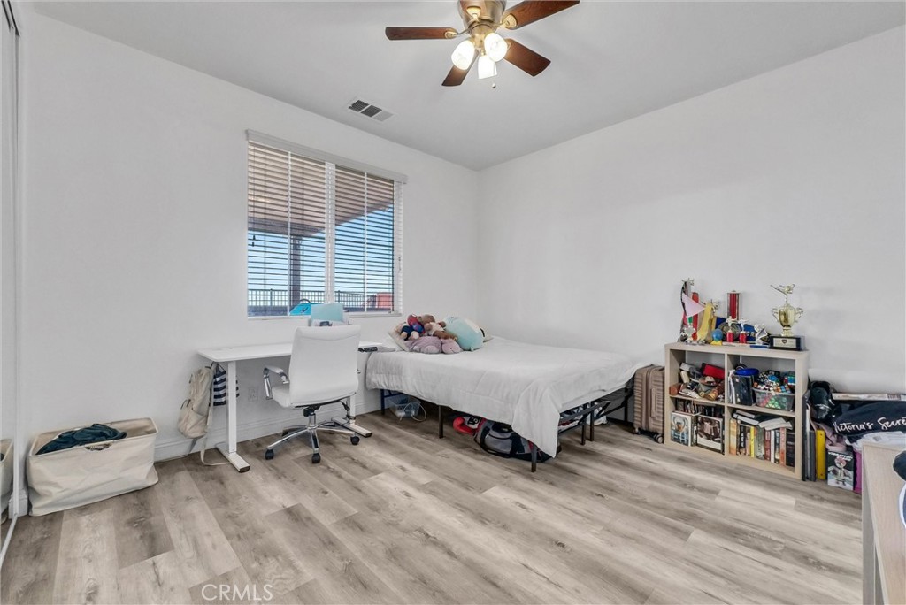 18388 Hidden Ranch Road Riverside, CA 92508 - Photo 21 of 49 a spacious bedroom with a bed and a table in it