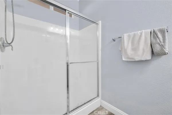 a bathroom with a shower and a walk in closet