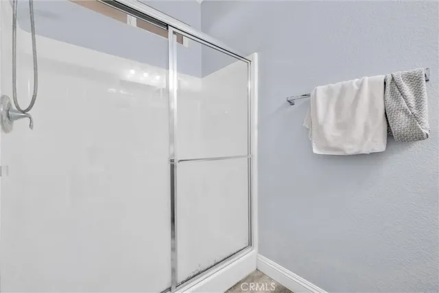 a bathroom with a shower and a walk in closet