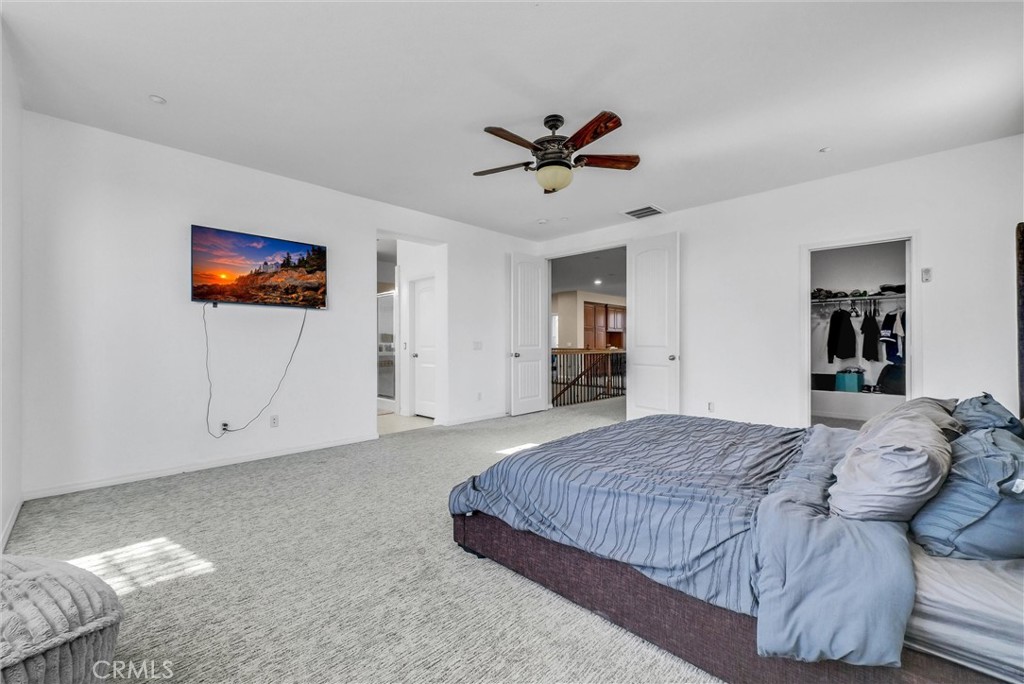 18388 Hidden Ranch Road Riverside, CA 92508 - Photo 26 of 49 a spacious bedroom with a bed and a view of kitchen