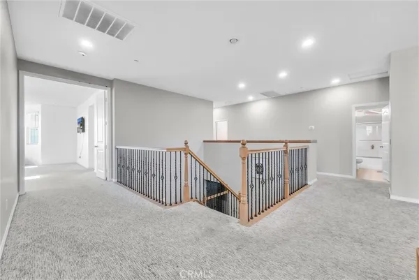 a view of a hallway with entryway and stairs