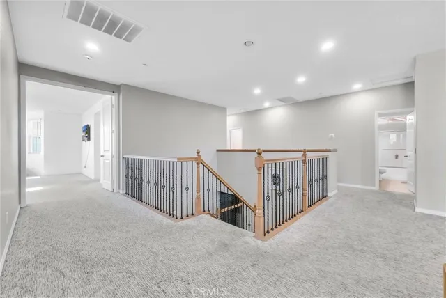 a view of a hallway with entryway and stairs