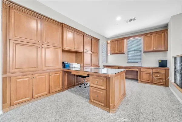 a kitchen with granite countertop a sink stove and cabinets