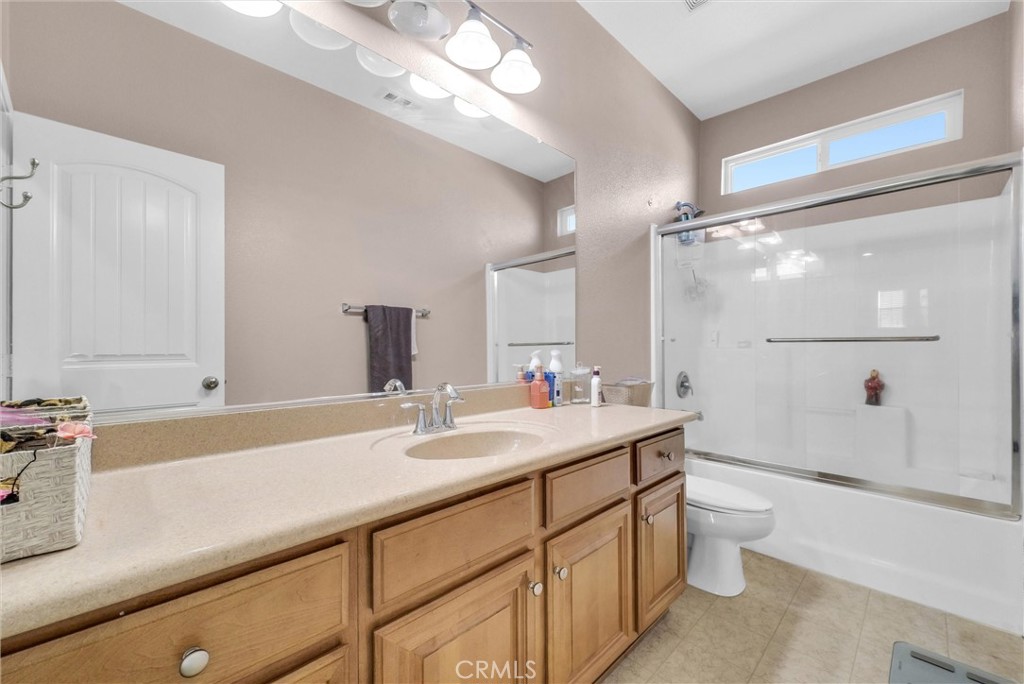 18388 Hidden Ranch Road Riverside, CA 92508 - Photo 39 of 49 a bathroom with a sink a toilet a mirror and shower