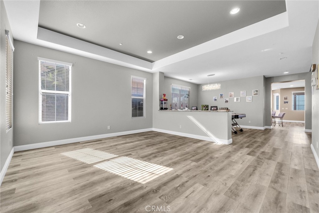 18388 Hidden Ranch Road Riverside, CA 92508 - Photo 4 of 49 a view of empty room with wooden floor and window