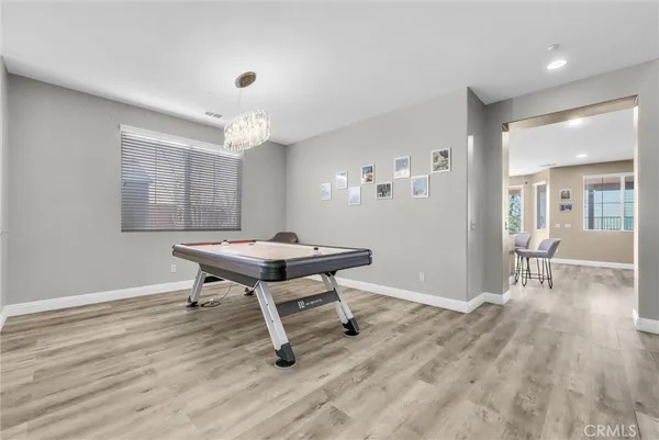 a view of a workspace with furniture window and wooden floor