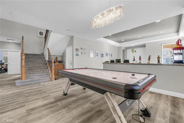 a room with furniture pool table and window