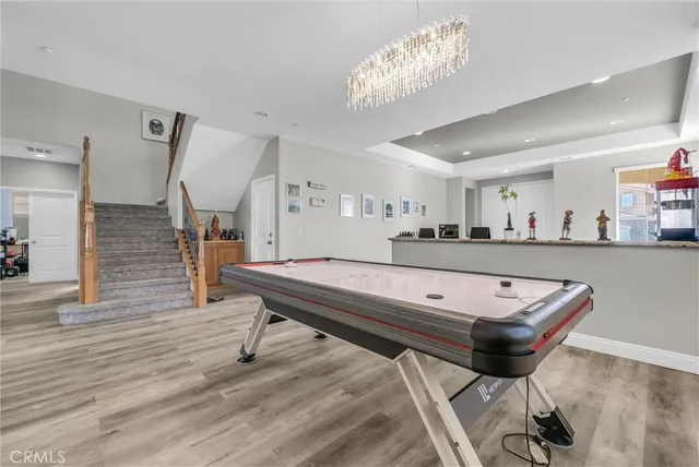 a room with furniture pool table and window