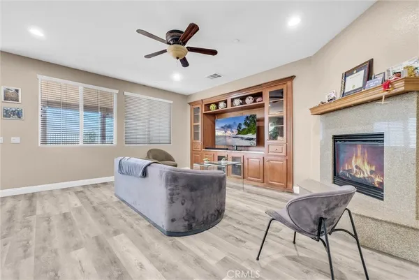 a living room with furniture and a flat screen tv with wooden floor