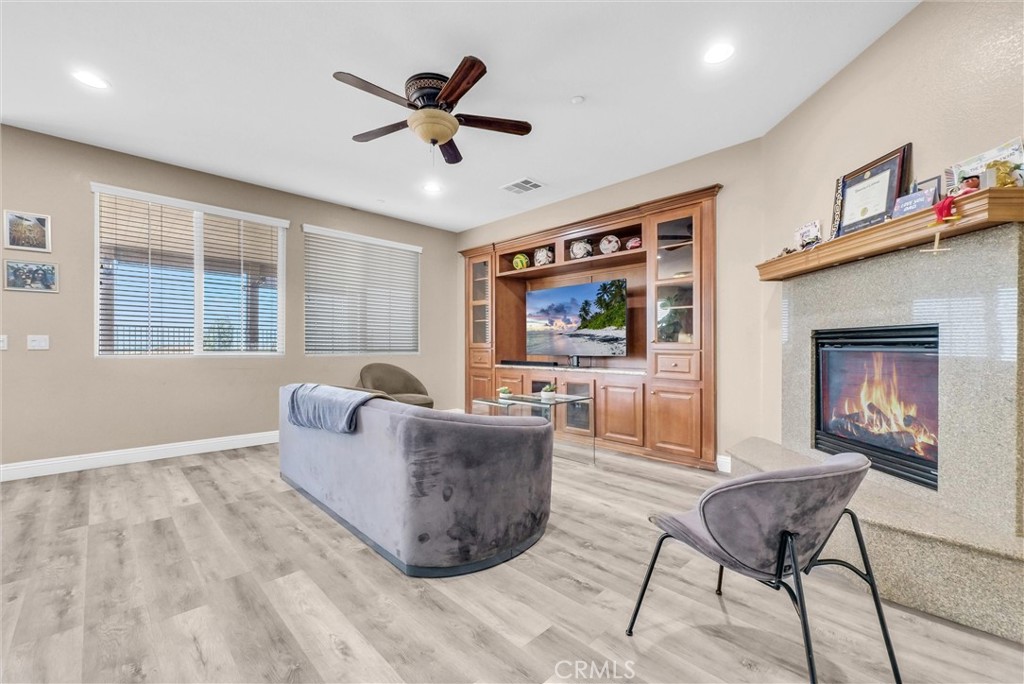 18388 Hidden Ranch Road Riverside, CA 92508 - Photo 10 of 49 a living room with furniture and a flat screen tv with wooden floor