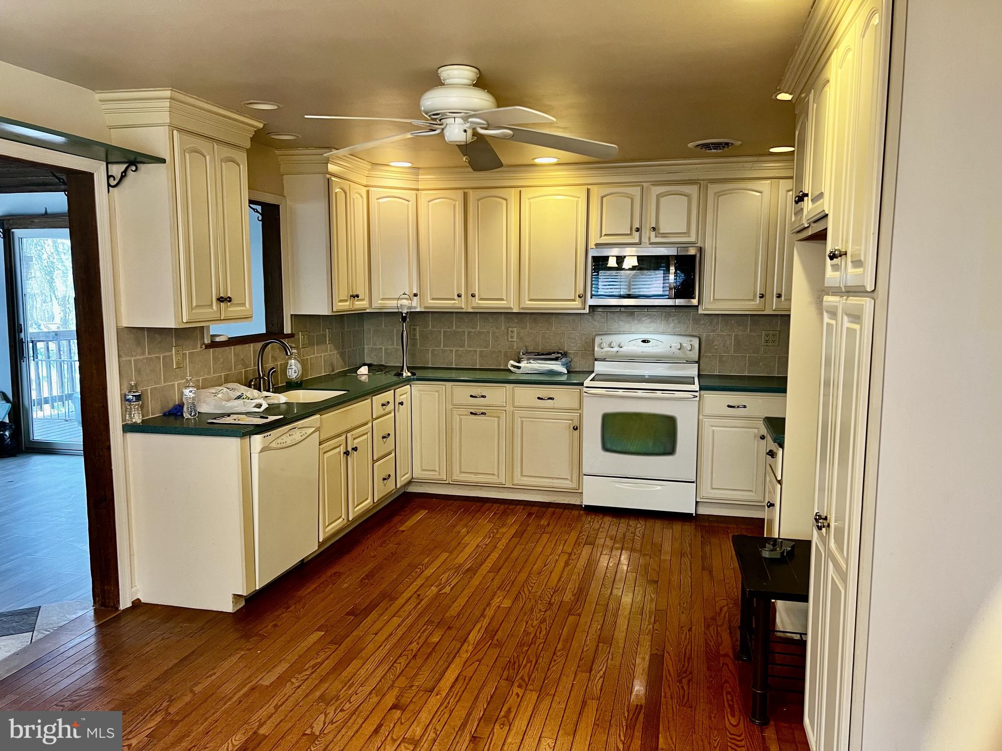 139 Carter Road Elkton, MD 21921 - Photo 6 of 27 a kitchen with kitchen island granite countertop a sink cabinets and wooden floor