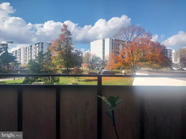 a view of a balcony with floor to ceiling windows and wooden deck