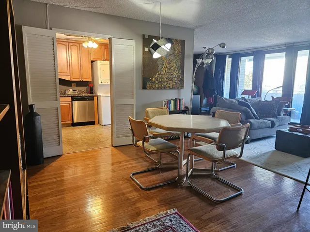 a view of a dining room with furniture window and wooden floor