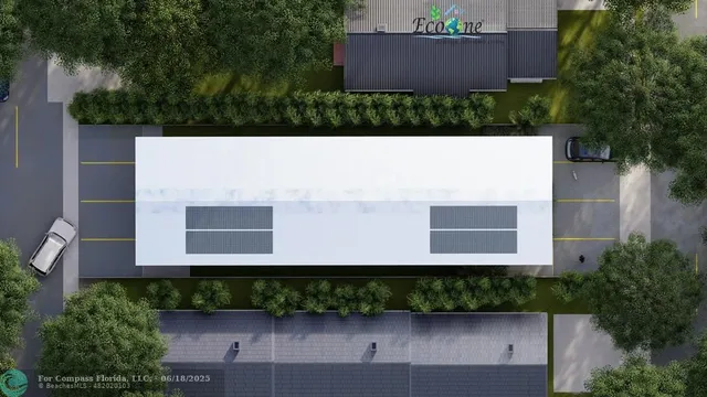 an aerial view of a house with a yard and a large tree